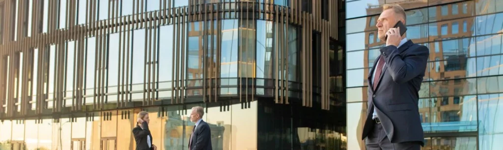 RideVoova branded coach picking up business professionals outside a modern office in London, Customised Corporate Coach Hire Services in London